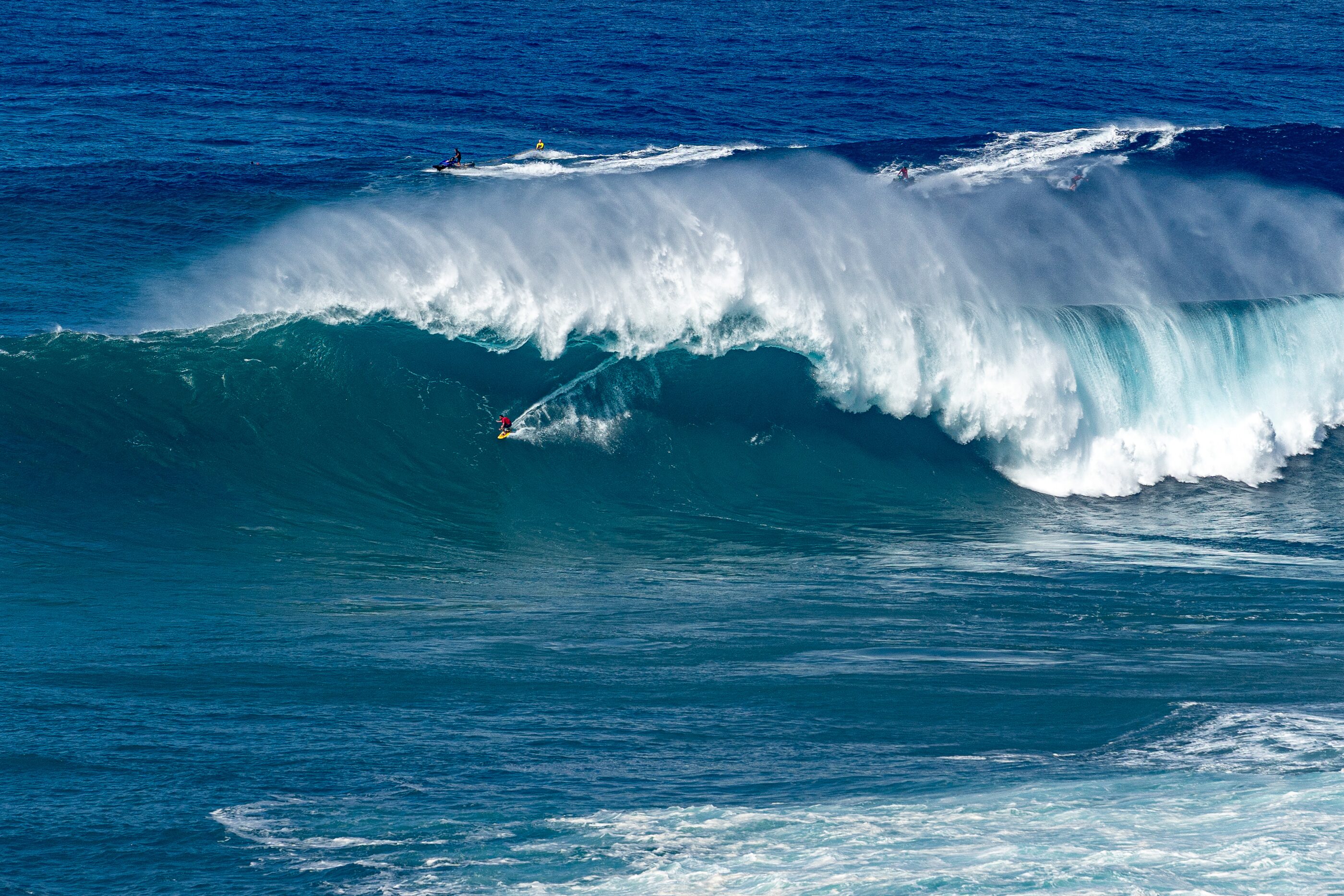 A powerful blue ocean wave breaking in open water