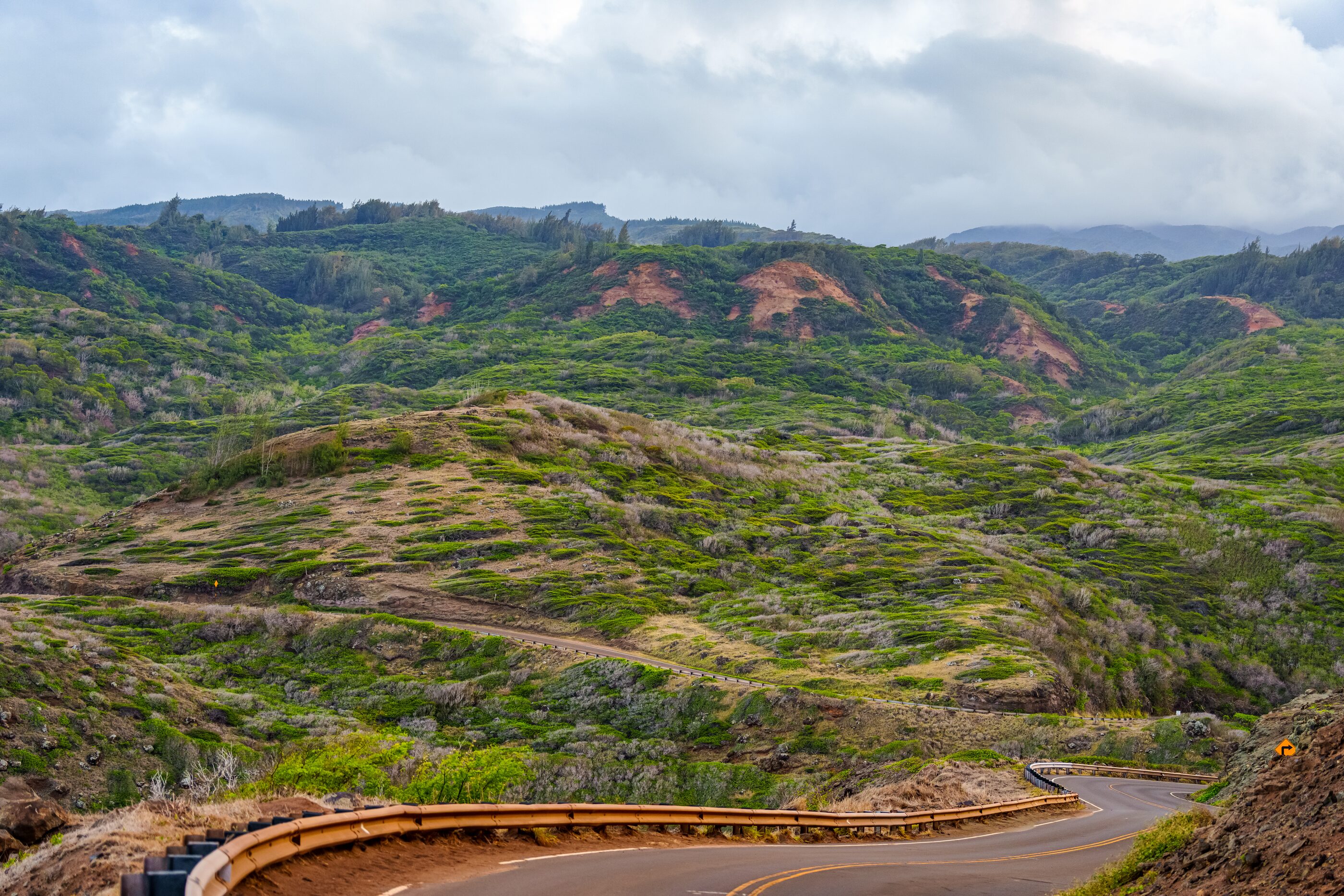 A winding road through a spare volcanic landscape